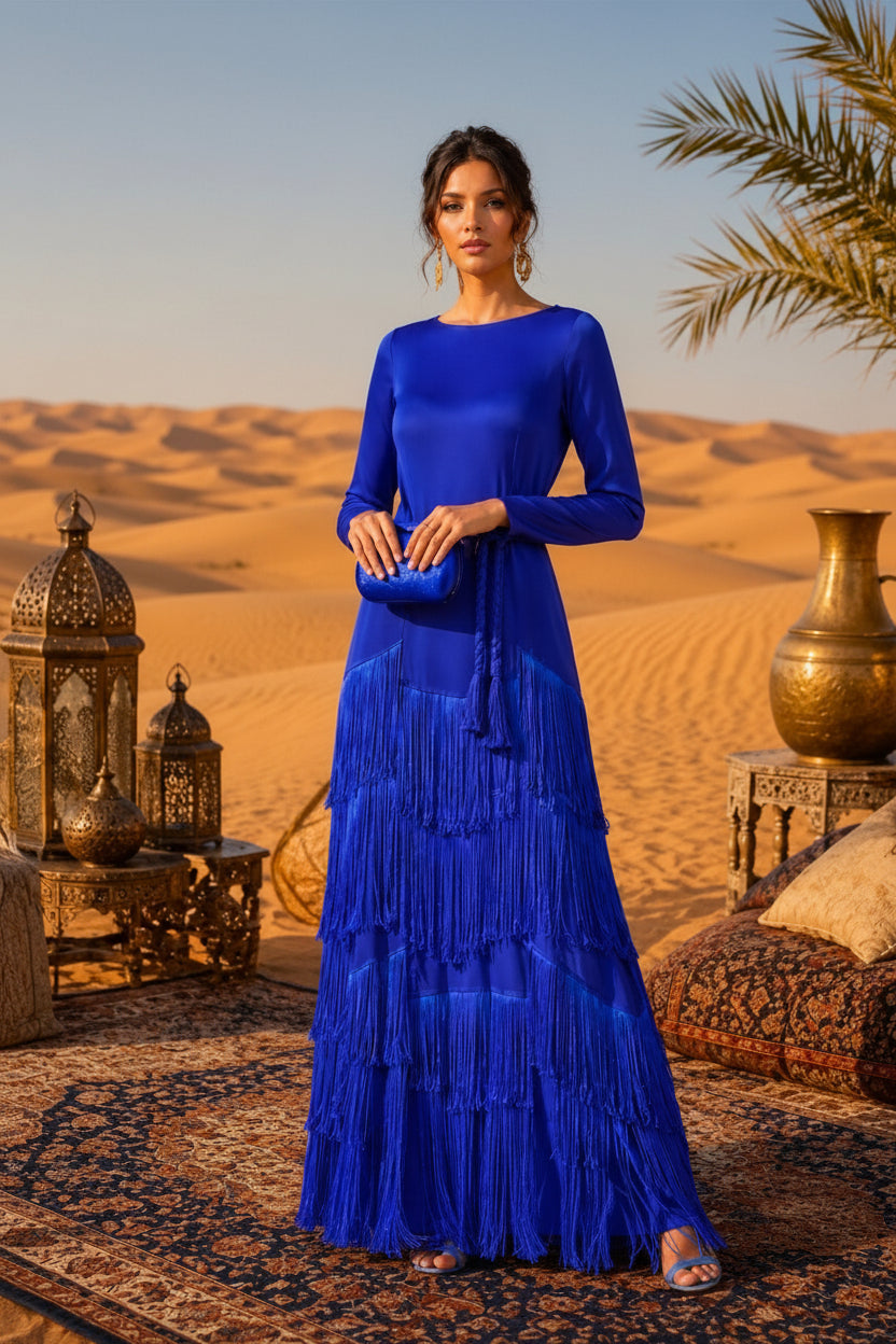 Woman in a blue dress standing in a desert setting with palm trees and decorative vases.