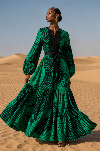 Woman in a green dress standing in a desert landscape